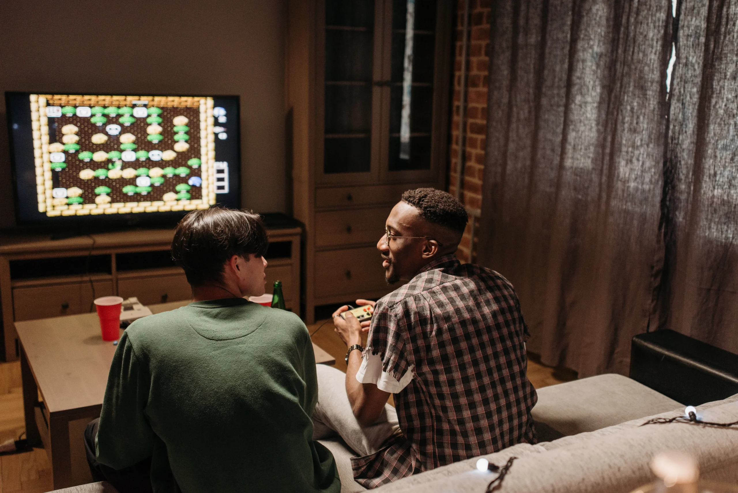 two friends playing a retro agme